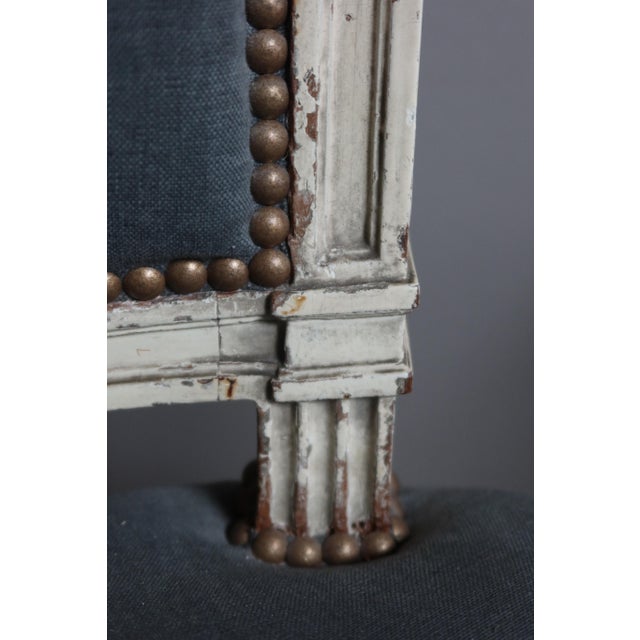 Suite of three armchairs in molded painted wood, Louis XVI period. These convertibles have basket handle backs and feet...