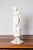 A French Neoclassical style marble sculpture from the 19th century depicting a nymph after the bath on a gray and white...