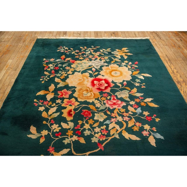 An exquisite Antique Chinese Art Deco carpet, circa 1920. Measuring 5' 10" x 8' 6", this piece features a vibrant and...