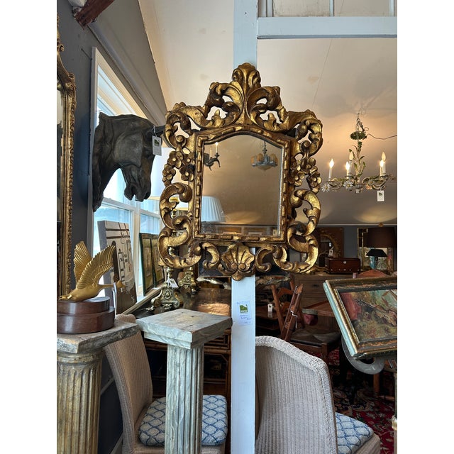 Beautifully carved giltwood Italian antique mirror having shell motif and marvelous warm aged patina. Fay Details...
