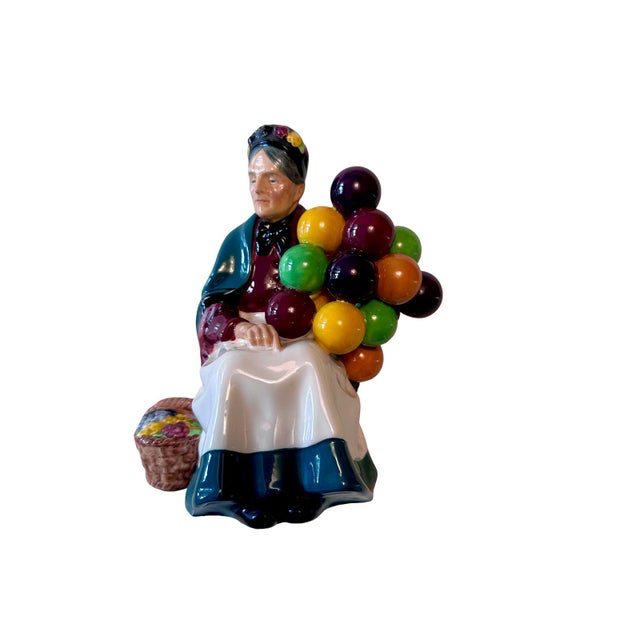 A charming pair of vintage Royal Doulton figurines: The Old Balloon Seller (HN 1315) and The Balloon Man (HN 1954),...