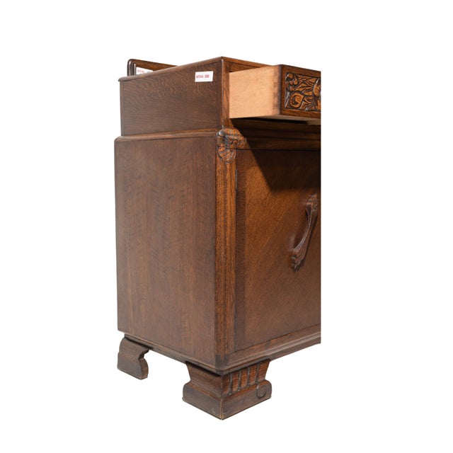 Heavy oak, carved details, and absolutely no interest in disappearing into the background. This vintage Tudor Revival...