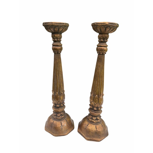 Elegant pair of vintage Neoclassical candlesticks featuring fluted column shafts accented with carved lotus and foliate...