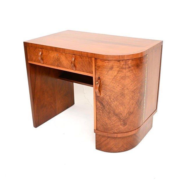 A stunning original Art Deco figured walnut desk. This was made in England, it dates from the 1930’s. It is an unusual...