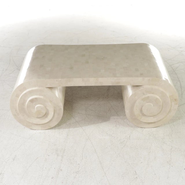 This tessellated fossil marble scroll coffee table by Maitland Smith is rarely found for sale. This sophisticated piece...