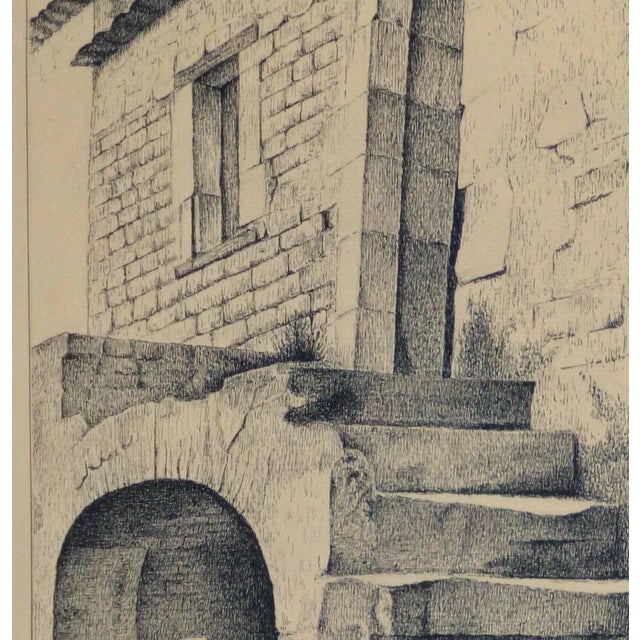 Vintage French lithograph of a rustic stone building and stairway with a figure in the shade of an alcove by artist Andre...