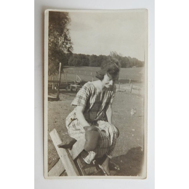 Early 20th century snapshot photograph of girl wearing a boxing glove. Unframed, corner bumps.