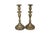 A pair of traditional turned candlestick holders in brass. Simple baluster columns are turned with sleek wax pans and...