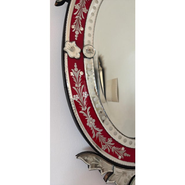 Venetian mirror with rare ruby/cranberry glass border embellished with intricate silver floral & foliage etchings.