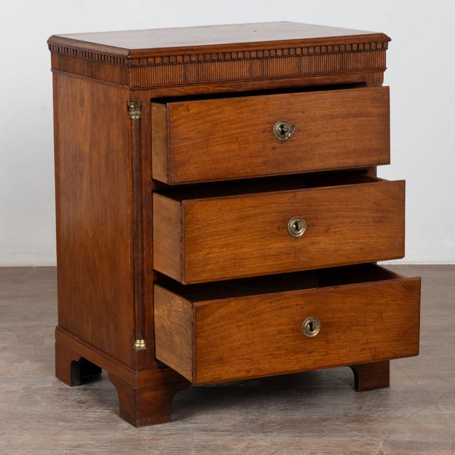 Mid19th century Louis XVI style chest of three drawers crafted in mahogany. The chest features dentil carving along the...