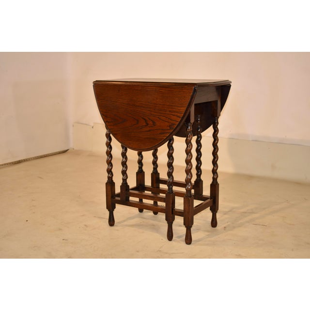 Circa 1900 English Oak side table with gate-legs. The top of the table has nice graining and a beveled edge. It measures...