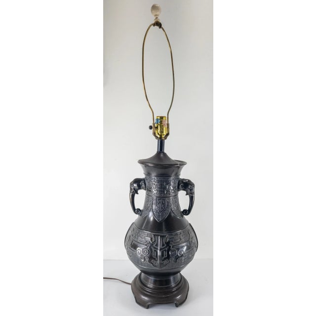 We are selling this nice mid century Chinese chinoiserie style lamp. This bronze lamp is in a Chinese Ritual bronze form...