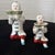 A graduating set of two vintage hand-painted porcelain figurines by the Hungarian manufacturer Herend. Formed as kneeling...