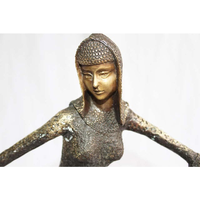 After Demetre Chiparus. An Art Deco style bronze figure. Mid-20th century. Of dark brown patination. On circular stepped...