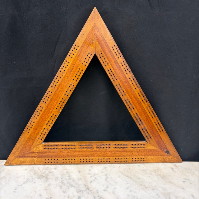 Handcrafted antique triangular cribbage board fashioned from beautifully figured hardwood with a rich honey-toned patina....