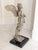 The work of art was created in 1999 and measures 30" in height including the beveled black granite base which measures 11"...