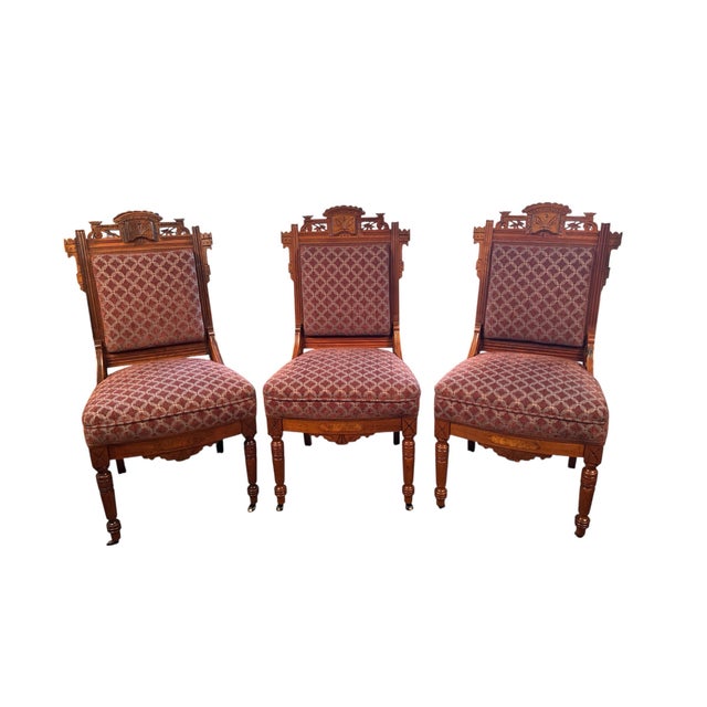 A handsome set of three late 19th century American Eastlake parlor chairs crafted in solid walnut. The chairs feature...