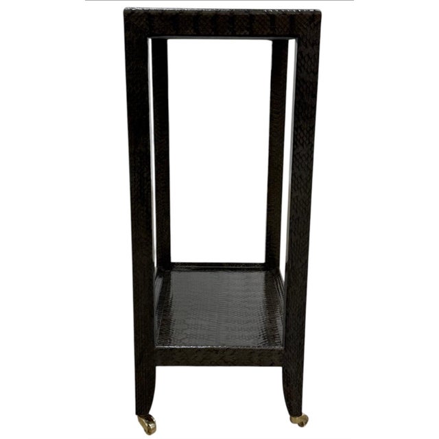 Iconic Karl Springer Attributed Telephone Table wrapped in finely detailed cobra skin. Brass casters to the feet and the...
