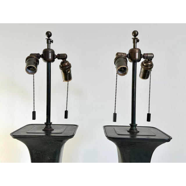 Outstanding pair of large Gu form archaistic Chinese style table lamps. Beautifully detailed with and well executed...