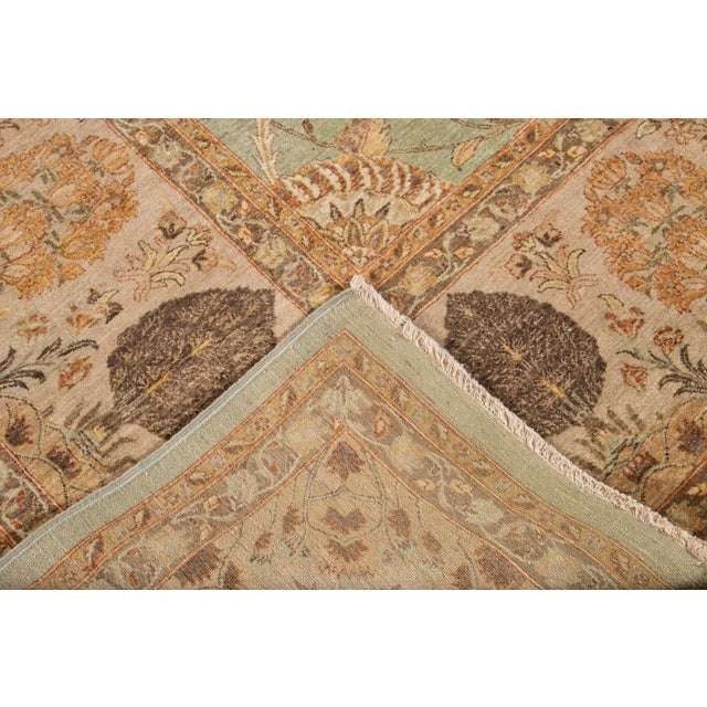 This Tabriz-style wool rug boasts a splendidly intricate floral design, classically presented in a green color field,...