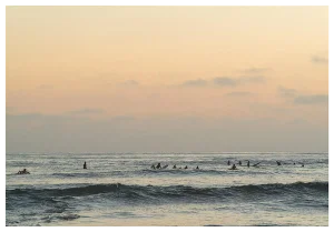 Ocean With Surfers in Pastel Photograph