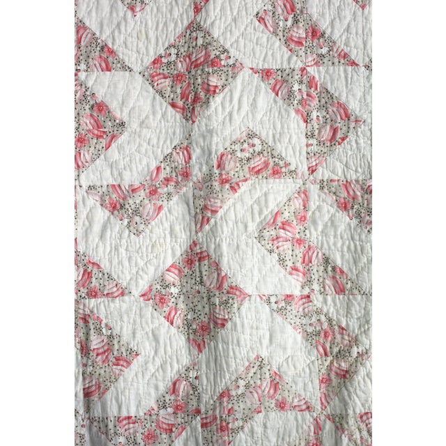 Wonderful great antique condition quilt. Primarily pink and white squares and ditzy or sack cloth mixed windmill pattern....