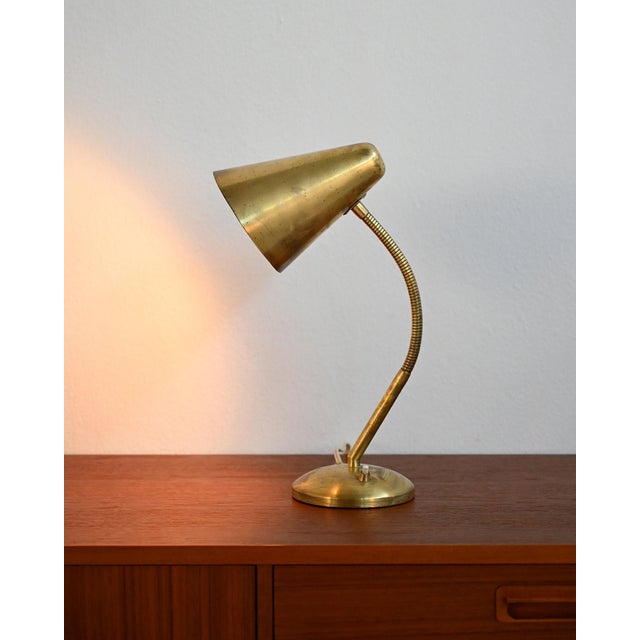 Brass lamp with original patina, flexible stem, and adjustable conical shade. Scandinavian production from the 1950s. Made...