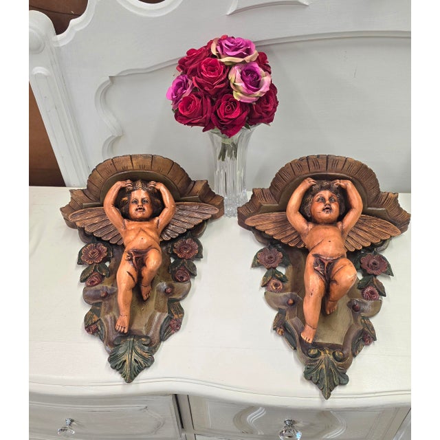 A pair of old world Italian wall sconces. Hand carved and painted wooden shelf sconces. Red roses and leaves carved and...