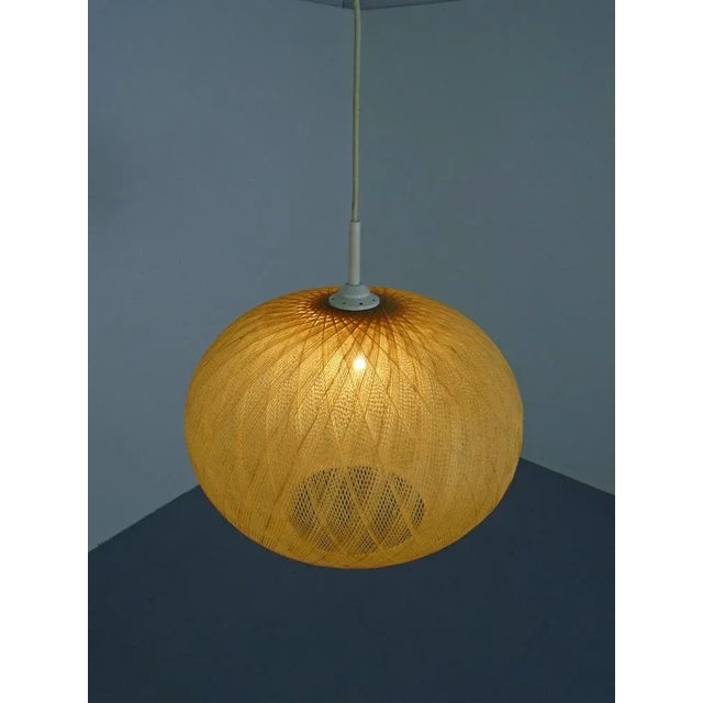 Pendant lamp made of spun fiberglass from the 1960s. Probably made in Germany. European Plug (up to 250V).The wiring of...