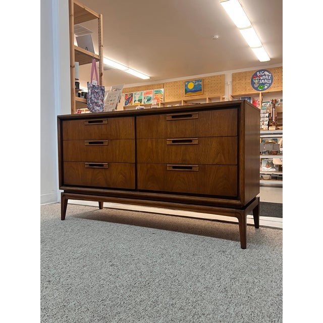 The mid-century modern solid walnut dresser set features a sleek and stylish design characteristic of the era. It includes...