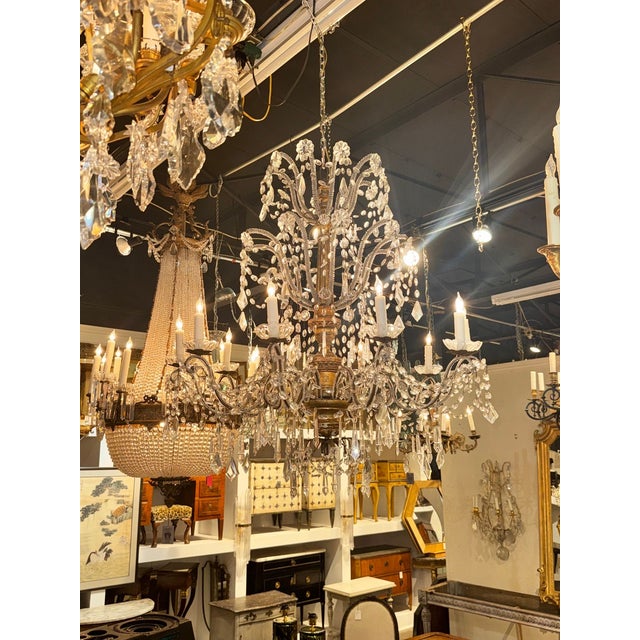 This large 19th-century Italian giltwood and crystal chandelier exudes elegance and sophistication. The intricate design...