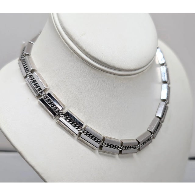1952 rhodium plated rectangular links with wedges on the long sides with rope pattern through the middle that is...