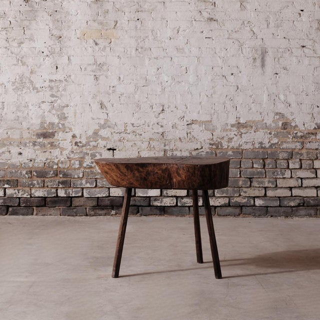 19th-century French provincial butcher block crafted from solid elm, featuring a thick, timeworn top and robust base. Rich...