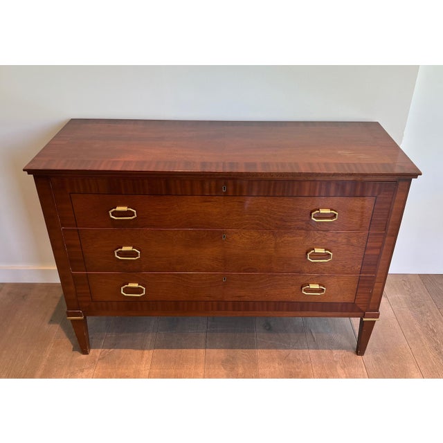 This beautiful and elegant neoclassical chest of drawers is made of mahogany veneer and brass. It is a French work. Circa...