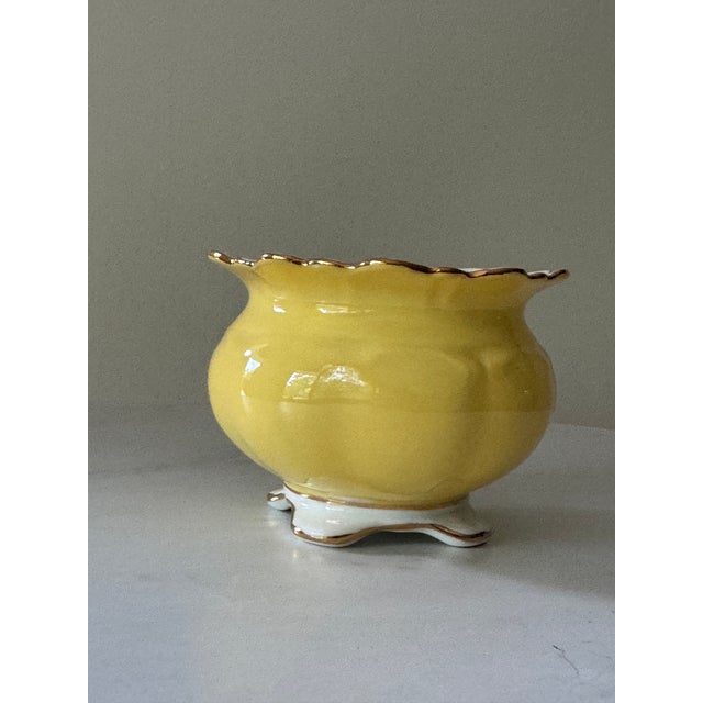 A cheerful and elegant little piece from one of England’s finest china houses, this Aynsley bone china cachepot is...