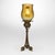 This exceptional Tiffany Studios Tripod candlestick with Feather Favrile glass shade was created in the United States by...
