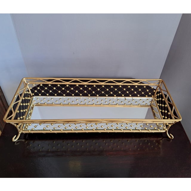 This vintage tall sided vanity mirror is detailed with a basket weave with round beads and wave design at rim. Nice alone...