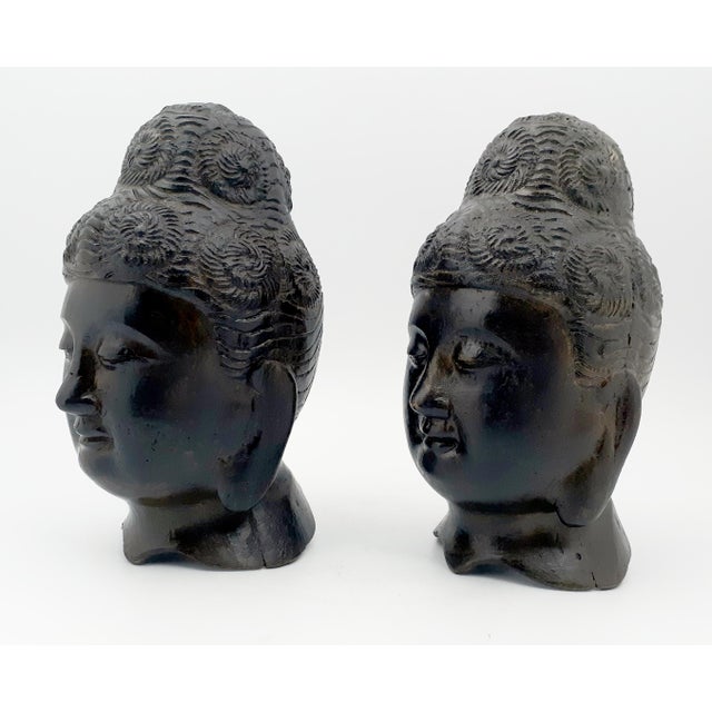A pair of Chinese bronze Buddha heads, finely carved, in meditation repose, with clockwise early Gandharan style hair...