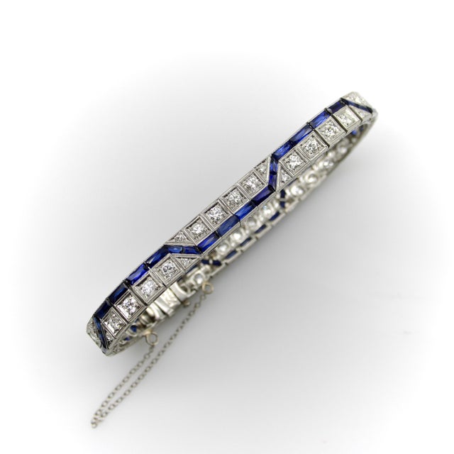 This is a sophisticated variation of a classic Art Deco line bracelet featuring rows of sparkling diamonds and sapphires....