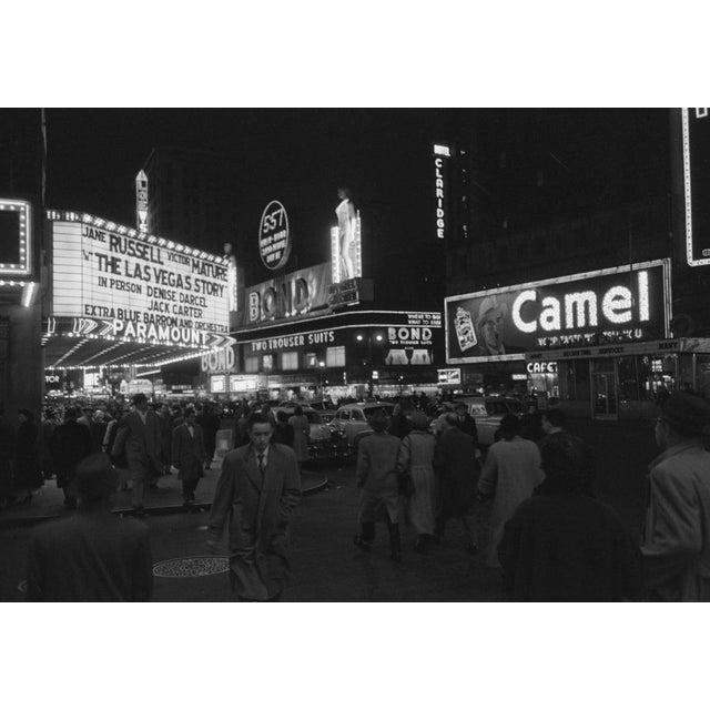 Signs On Broadway The Bond clothing store opposite the Paramount movie theatre on Broadway, New York City, 1952. The...