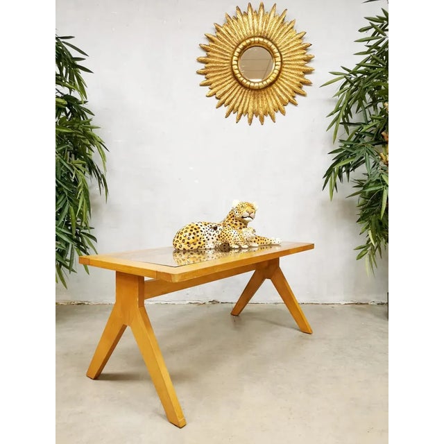 A wonderful vintage wooden coffee table with shelf webbing. Period: 50/60 years. Designer unknown, in style of pierre...