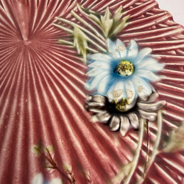 A charming Villeroy & Boch majolica plate featuring a raised butterfly and floral motif against a soft pink ground. The...