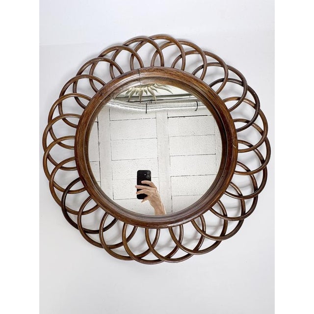 Round bentwood mirror, France, 1960s. An elegant French wall mirror in bentwood, characterized by its circular frame...