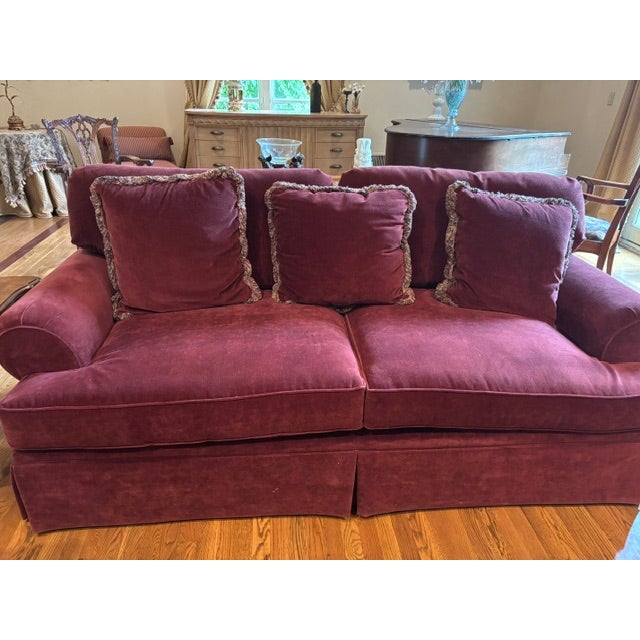 Bring timeless elegance into your home with this beautiful pair of oversized sofas upholstered in a rich red velvet....