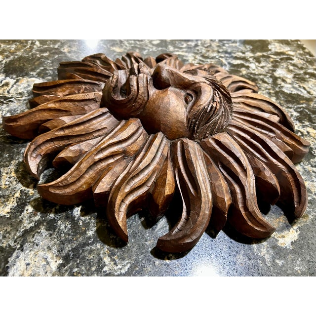 A large, hand-carved sun face, with deeply carved, radiating rays and very robust facial features. 3.9 lbs