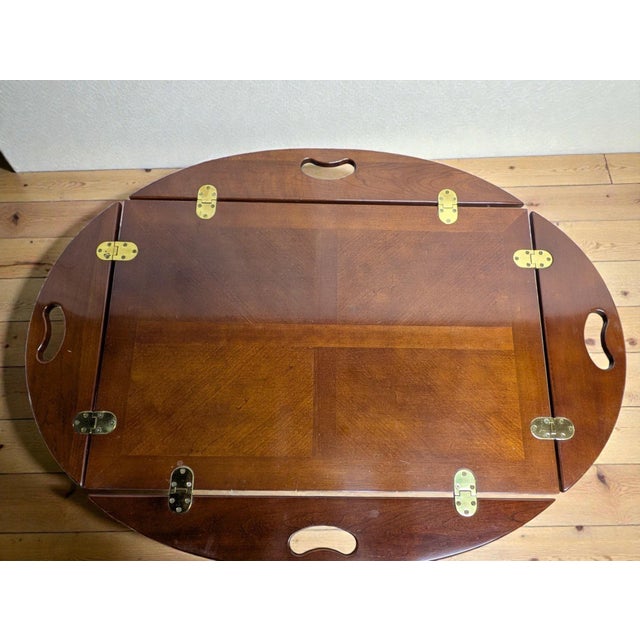 A vintage rectangular butler’s tray top coffee table with a shaped and hinged oval gallery top with hinged drop-leaf side...