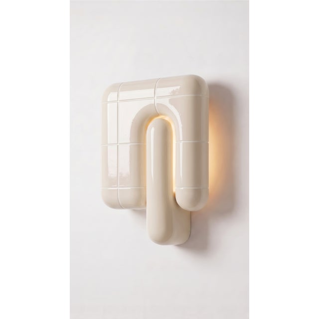 The smallest lamp in the collection, and often the first one people reach for. Its folded form hides the source entirely,...