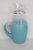 This gorgeous round Pitcher is made of glass. This lovely pitcher features a beautiful Blendo style to the glass with a...