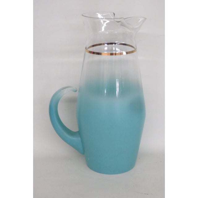 This gorgeous round Pitcher is made of glass. This lovely pitcher features a beautiful Blendo style to the glass with a...