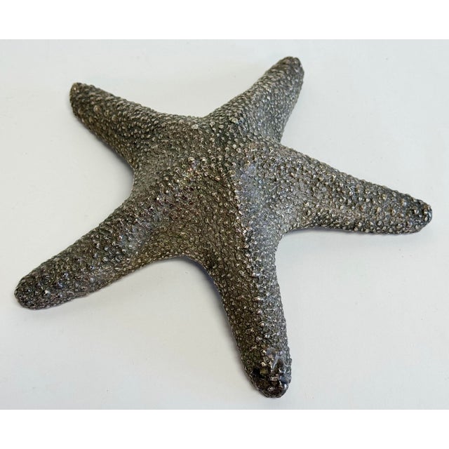 Hollywood Regency style heavy cast brass starfish paper weight. Beautiful detail to both sides. Natural patina to brass....
